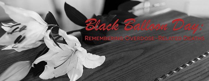 flower on table to remember overdose deaths on black balloon day