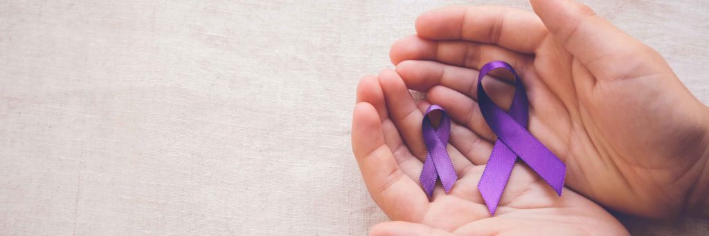 blue ribbons in hands for international overdose awareness day