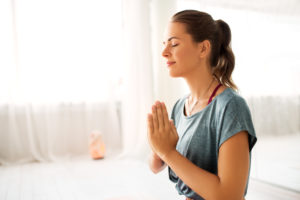 close up of woman meditating at yoga studio practicing mindfulness exercises