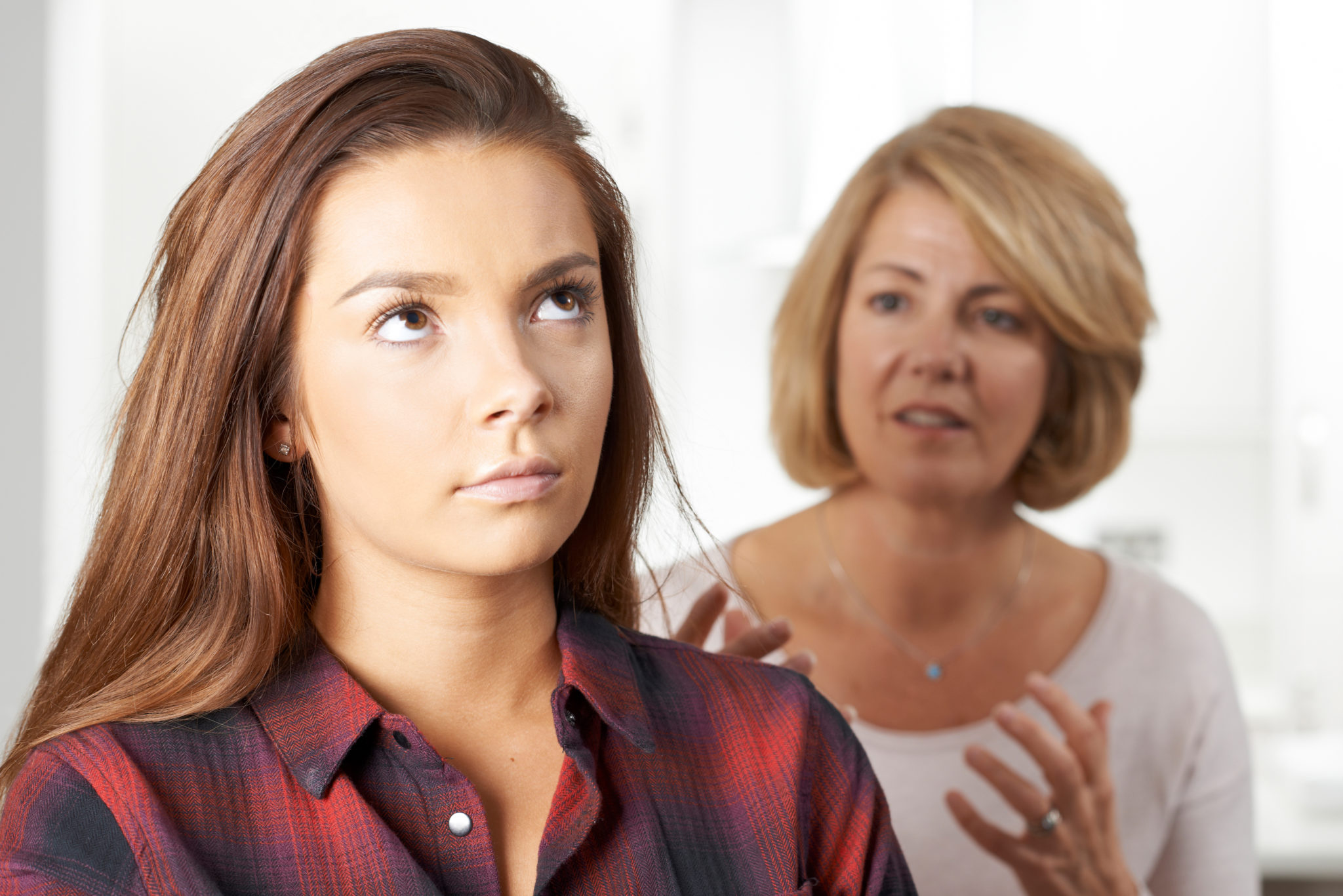 girl rolling eyes as being judged by mother not practicing mindfulness exercises