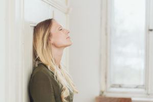 young blond woman taking a moment to relax practicing mindfulness exercises