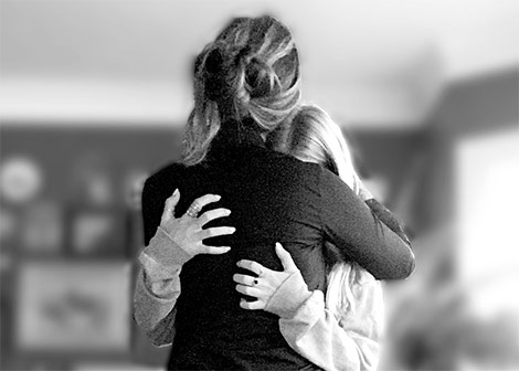 Mother hugging daughter