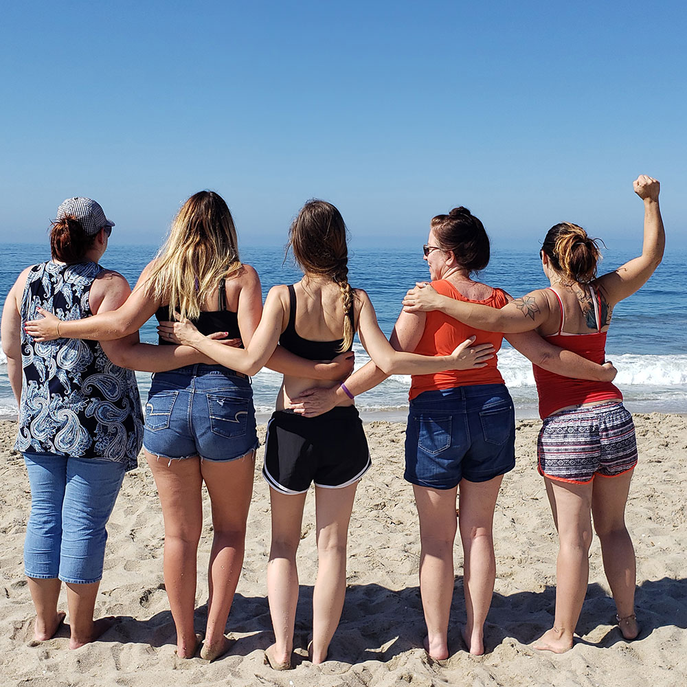 group of 5 women at the beach, on a beautiful sunny day
