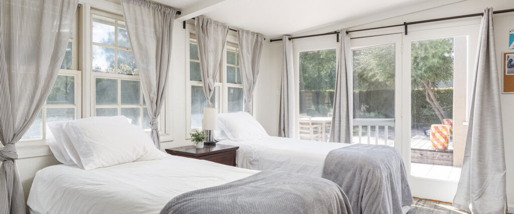 two beds in a well-lit bedroom