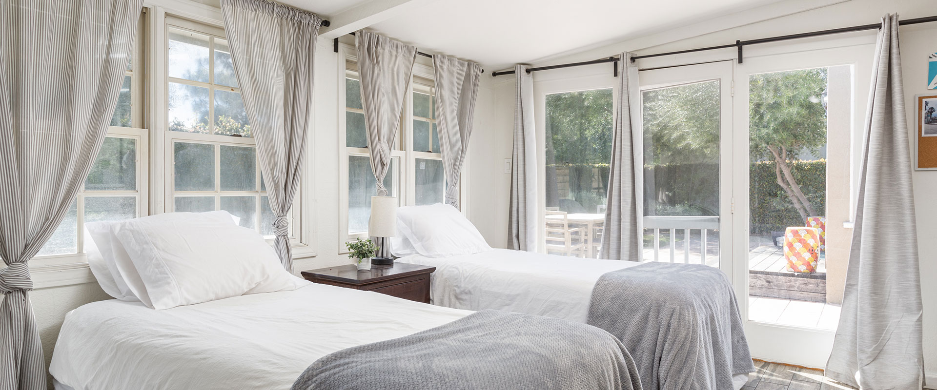 two beds in a well-lit bedroom