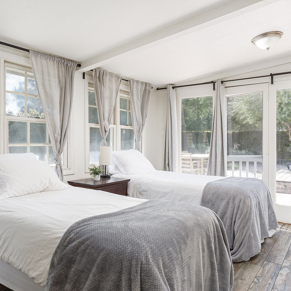 two beds in a well-lit bedroom