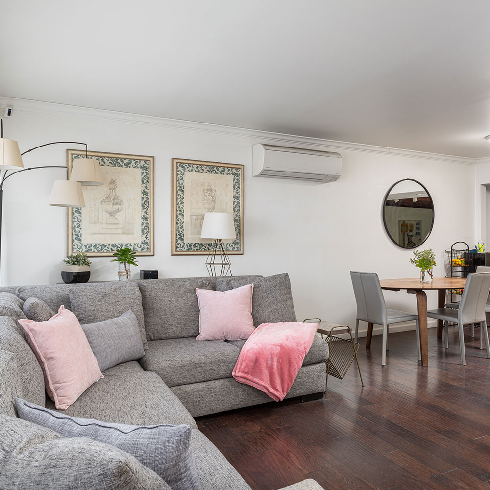 a gray couch in a comfortable, sunny living room