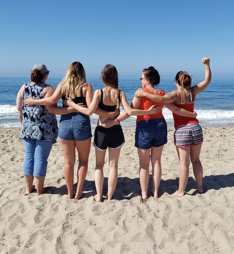 group of 5 women at the beach, on a beautiful sunny day