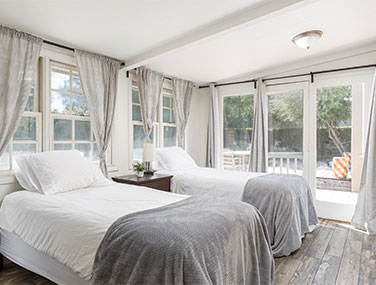 two beds in a well-lit bedroom