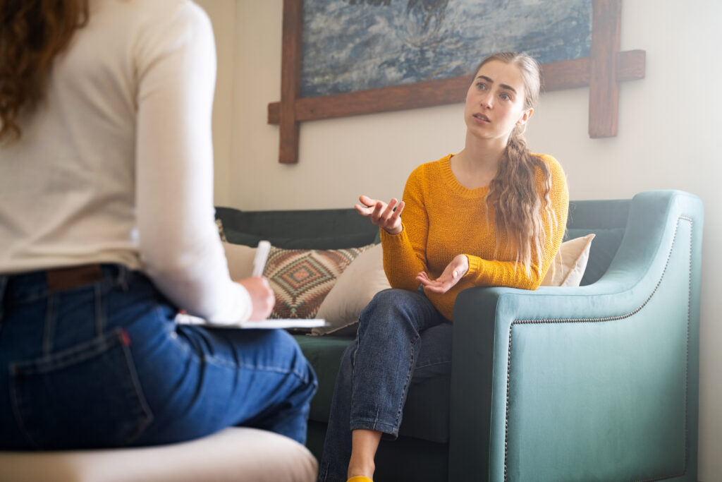 Woman talking with therapist in session.