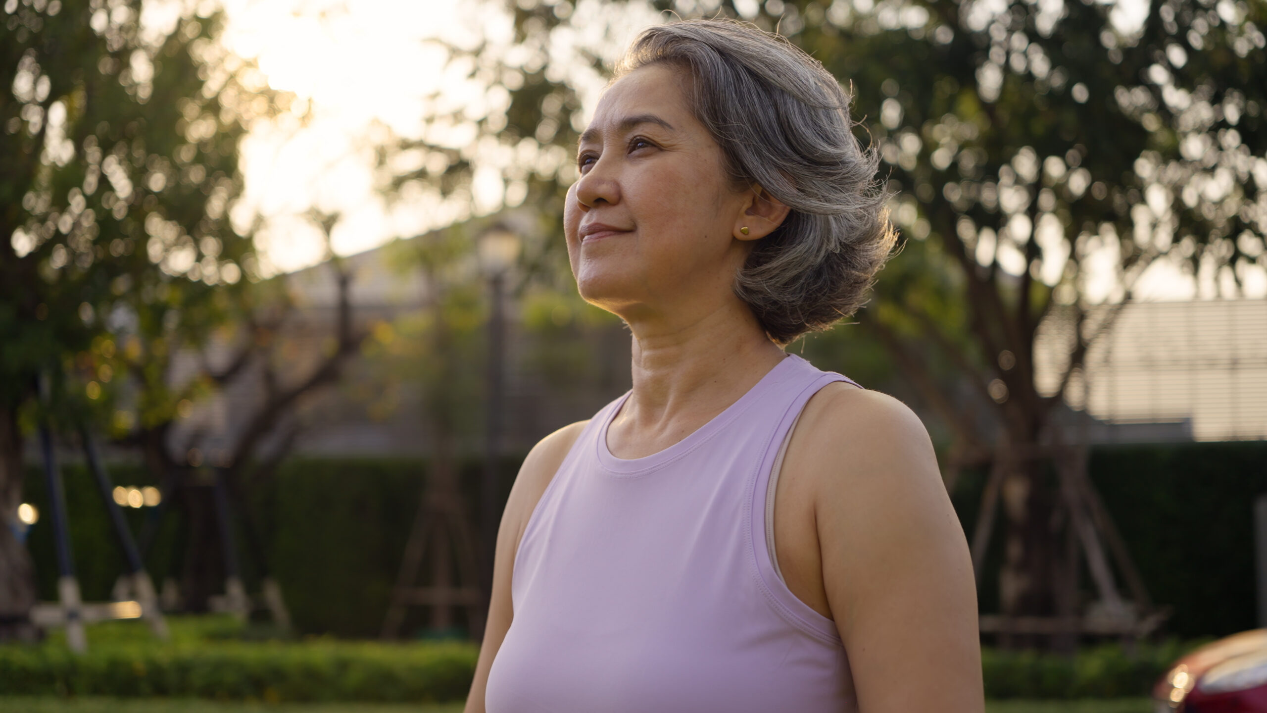 Woman standing outside looking peaceful.