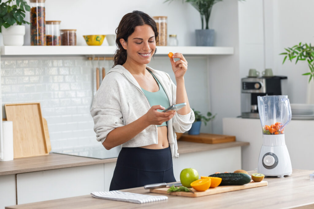 Woman eating healthy while checking phone.