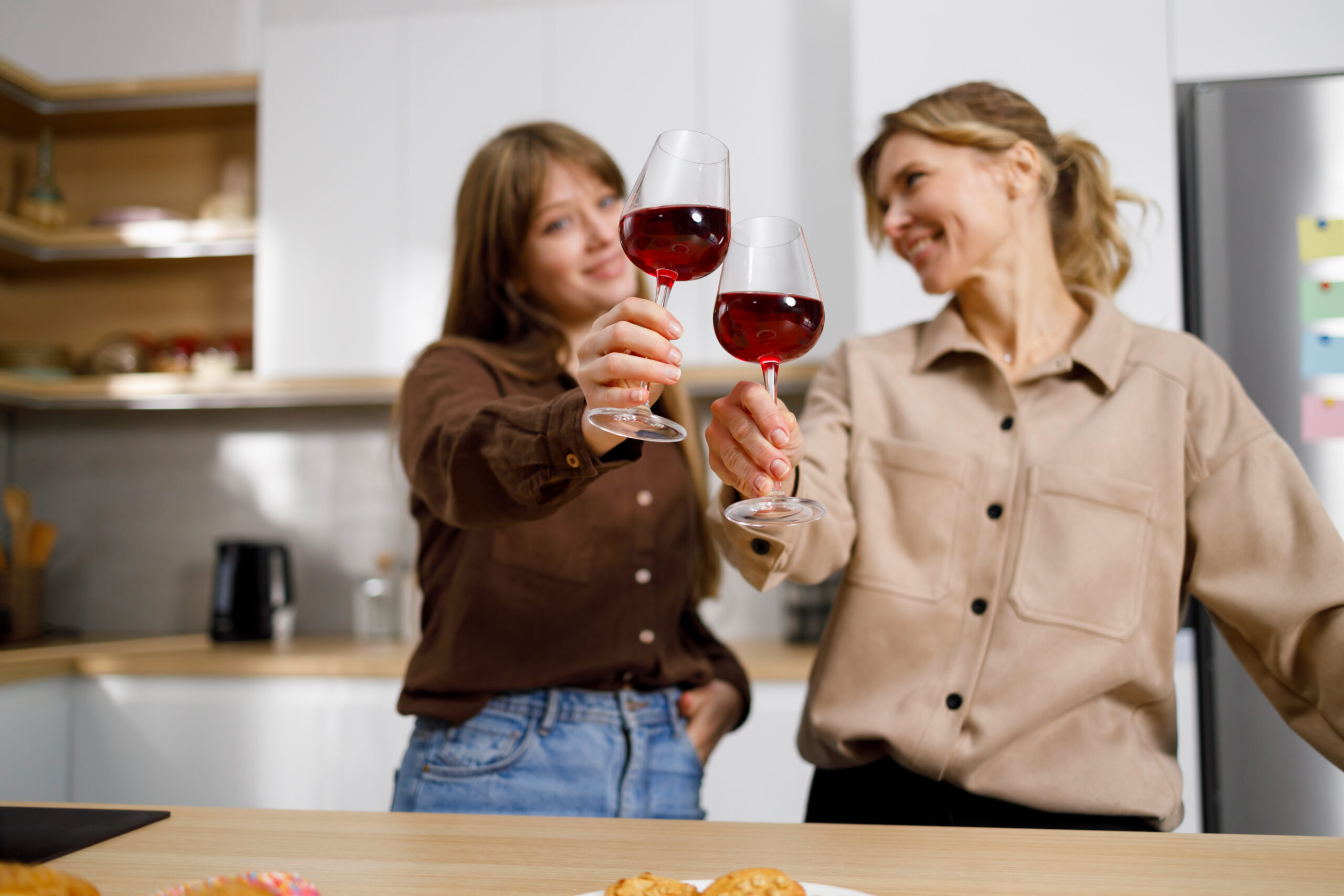 Women toasting wine symbolizing wine mom culture