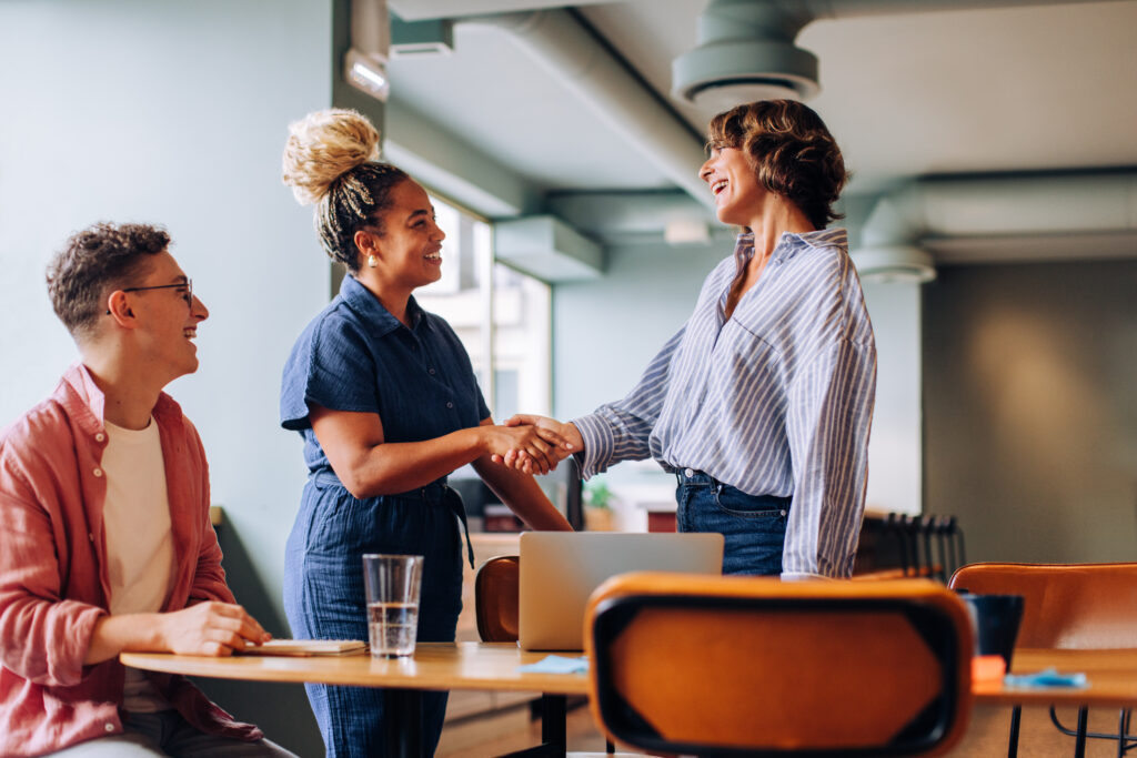 two women shaking hands
