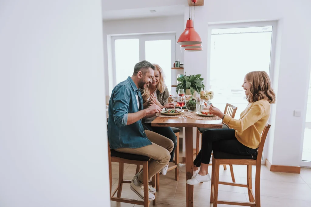 Family seated together around a dinner table during a meal